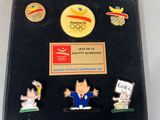 a picture of a collection of pins and magnets on a black case