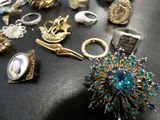 a table with a bunch of rings and other jewelry on it