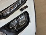 a close up of a car ' s headlight and front bumper