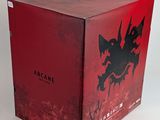 a red box with a black dragon on it sitting on a white surface