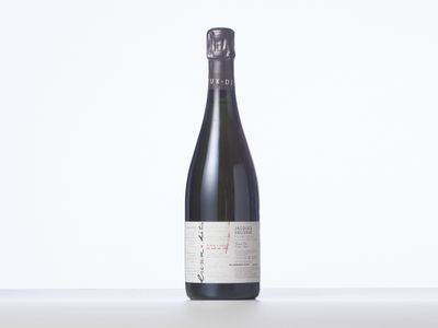 une bouteille de vin posée sur une table blanche