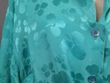 green dress with a floral pattern on it and buttons down the front