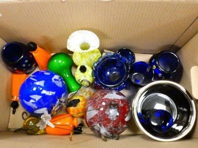 a cardboard box filled with assorted glass items