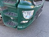 a green truck that is parked in the parking lot