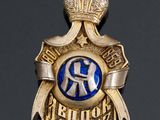 an image of a gold and blue badge with a crown on top