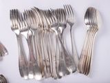 many forks and spoons laid out on the table