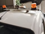 an image of a white truck with orange lights on top of it