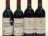 three bottles of red wine are lined up on a white surface