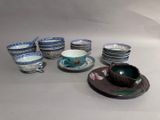 many plates and cups sitting on the table together