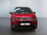 the red citrole is parked in a large room