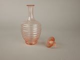 a small glass vase and a smaller glass bottle