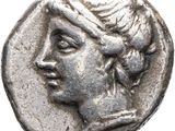 a silver coin with a woman ' s face on it