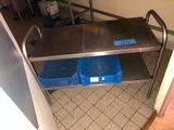 a stainless steel table with two blue crates on it