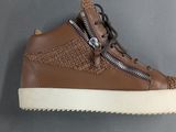 a close up of a brown shoe with a zipper on the side