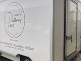 a delivery truck that is parked on the side of the road