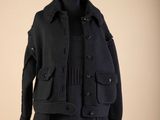 black wool coat on a mannequin stand