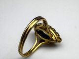 a gold ring with a black stone in the center