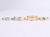 three gold and silver rings with blue sapphire stones