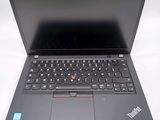 the laptop is open on a white surface with a black keyboard