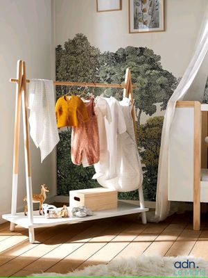 a baby ' s room with a crib and a bed with a canopy over it
