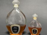 two bottles of liquor sitting next to each other on a table