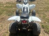 an image of a white four wheeler atv parked in a field