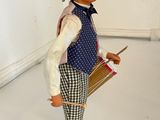 a figurine of a man with a hat and a cane