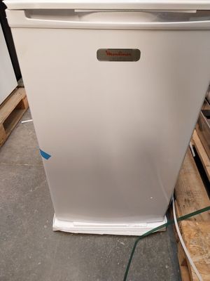 an image of a white refrigerator in a warehouse