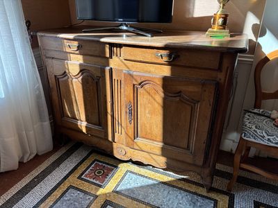 a television on top of a wooden cabinet in a living room