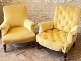 pair of yellow upholstered chairs in front of a stone wall