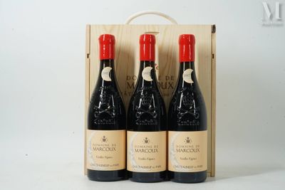 three bottles of wine in a wooden box on a white surface