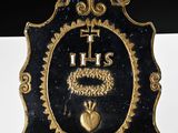 a black and gold clock with a gold heart on it