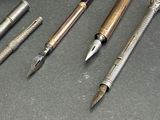 a lot of pens that are sitting on a table