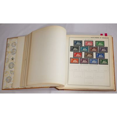an open book with stamps on it sitting on a table