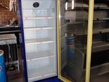 a refrigerator that is sitting in the middle of a room
