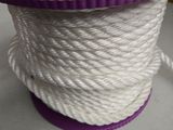 a spool of white rope with purple spool on top