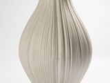 a white vase that is sitting on a table