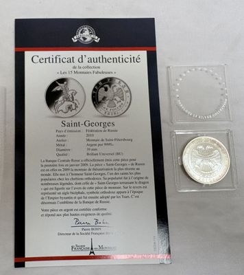 une pièce d'argent sur laquelle figurent les portraits d'une femme et d'un homme