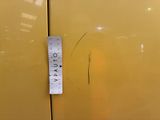 a ruler that is on the side of a yellow cabinet