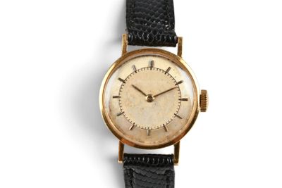 an image of a gold wrist watch with a black strap