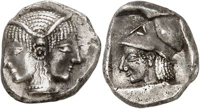 a silver coin with a woman and a man on it