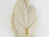 a sculpture of a leaf on a white surface