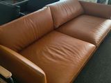 a couch that is sitting in a room with a chair