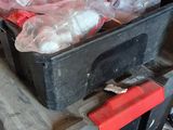 a man putting something in a red box on a cart