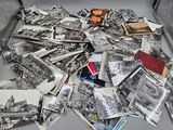 a suitcase full of old photos and a teddy bear in it