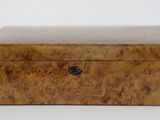 a small wooden box sitting on top of a white surface