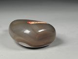pair of brown and white rocks sitting on top of a white surface