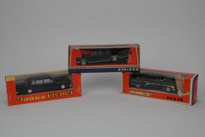 three boxed boxes of black toy cars on a white surface