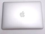 a white apple laptop sitting on a white table