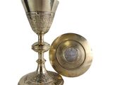 a silver goblet and a silver plate on a white background